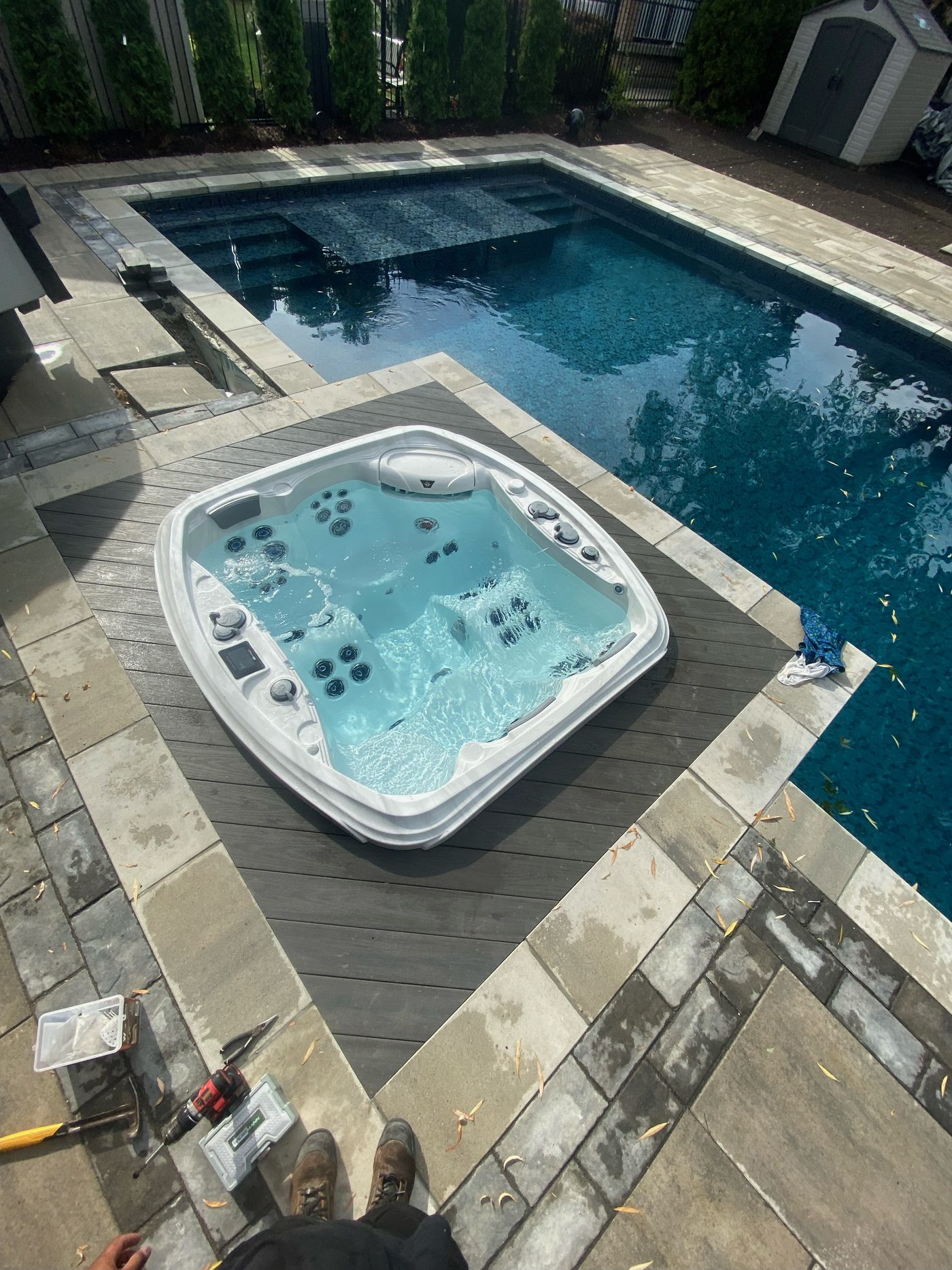 Decking installed around an in-ground hot tub beside a pool